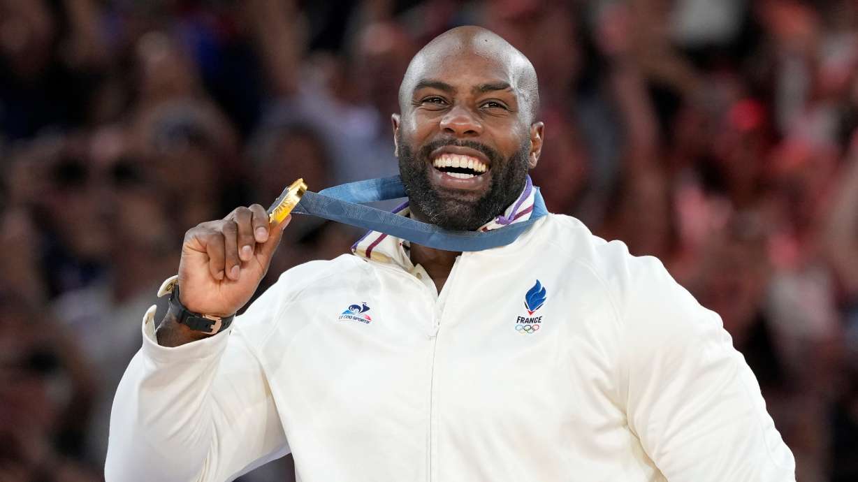 FILE - Golden medalist France's Teddy Riner poses on the podium of the judo men's +100 kg event in the team judo competition, at Champ-de-Mars Arena, during the 2024 Summer Olympics, Friday, Aug. 2, 2024, in Paris, France.