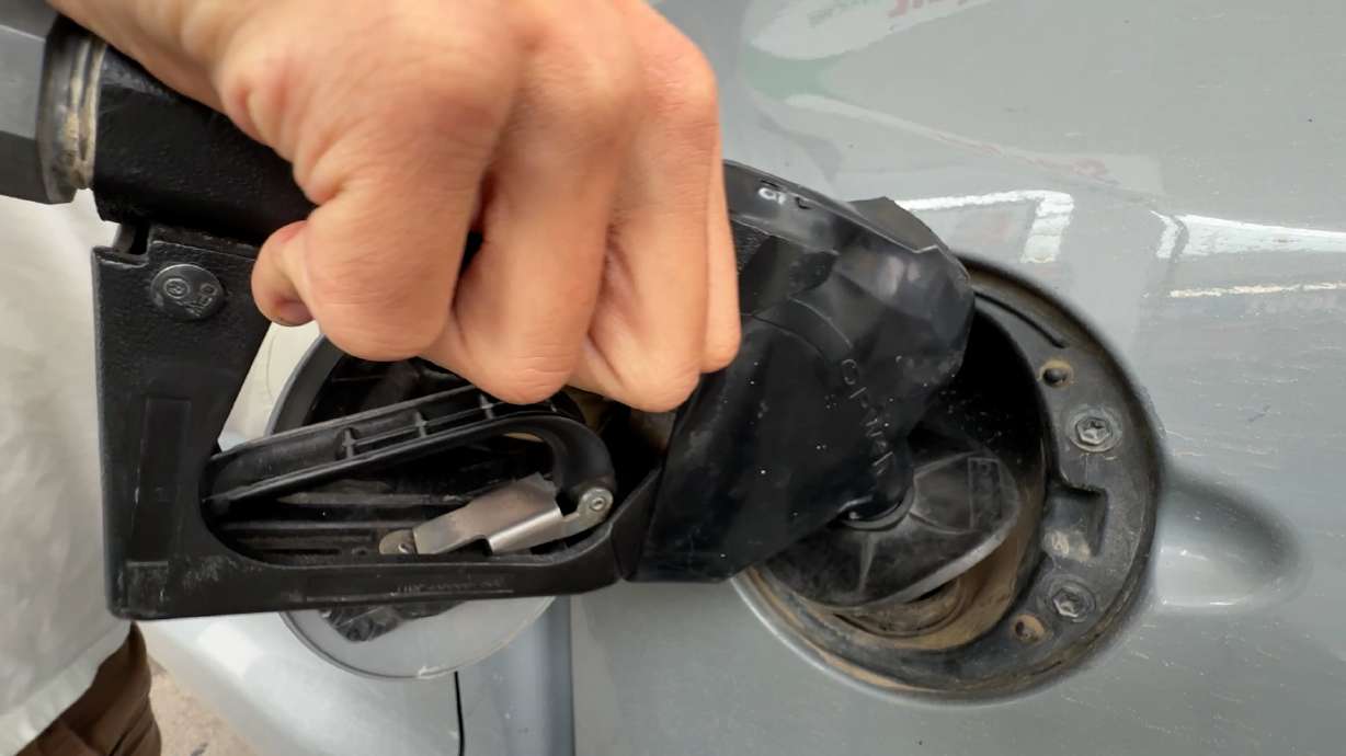 A driver fills up at a Utah gas station as rising fuel prices prompt many Americans to change their driving habits and look for ways to save at the pump.