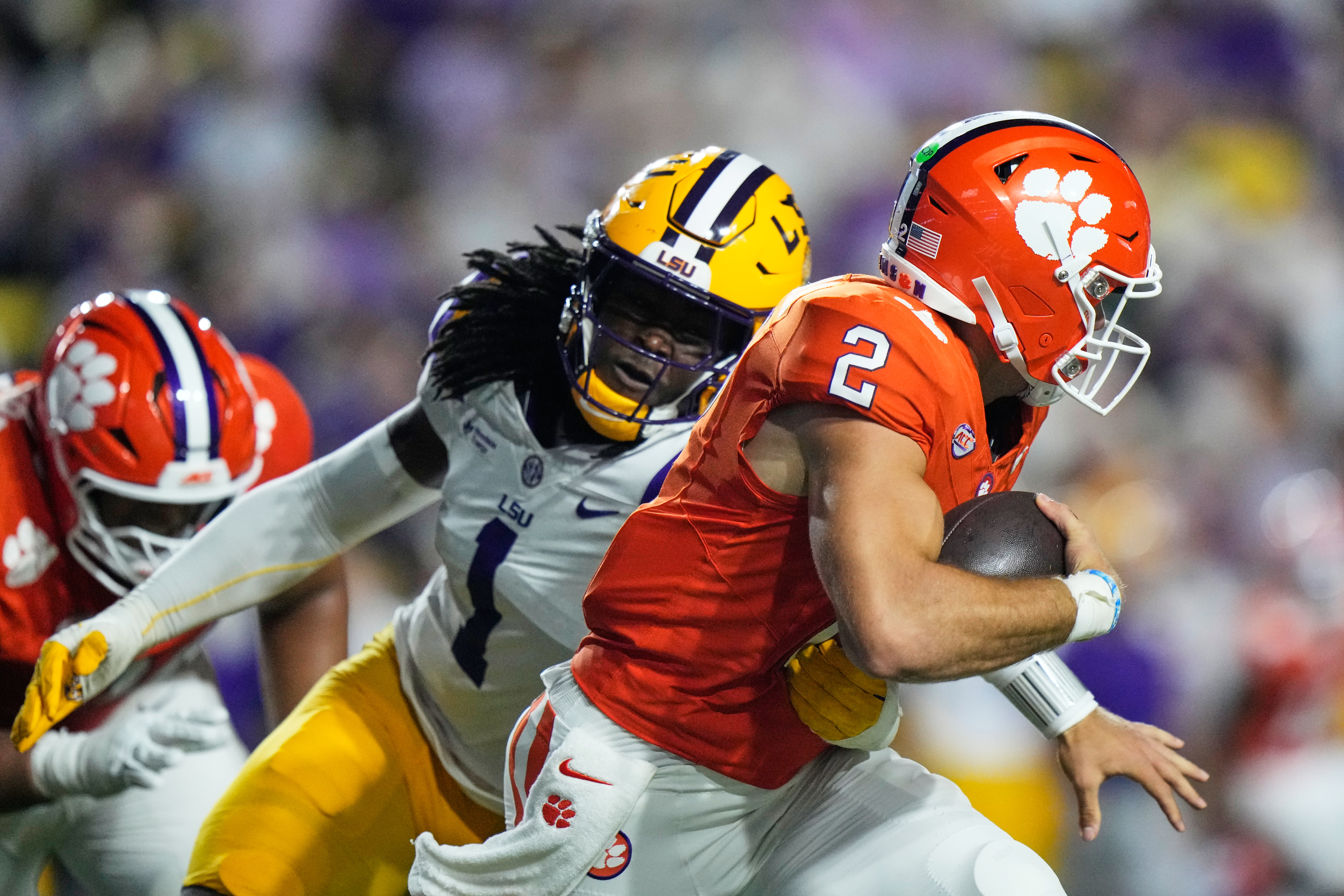Clemson quarterback Tait Reynolds (2) is sacked by LSU defensive end Princewill Umanmielen (1) in the first half of an NCAA college football game, Saturday, Sept. 5, 2026 in Baton Rouge, La. 