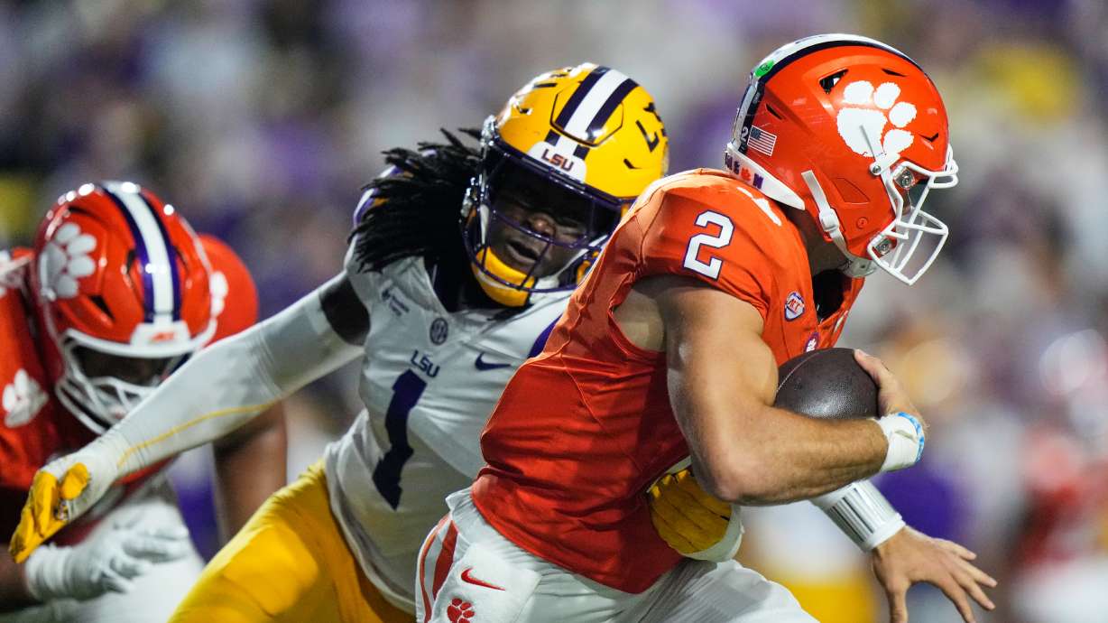 Clemson quarterback Tait Reynolds (2) is sacked by LSU defensive end Princewill Umanmielen (1) in the first half of an NCAA college football game, Saturday, Sept. 5, 2026 in Baton Rouge, La.
