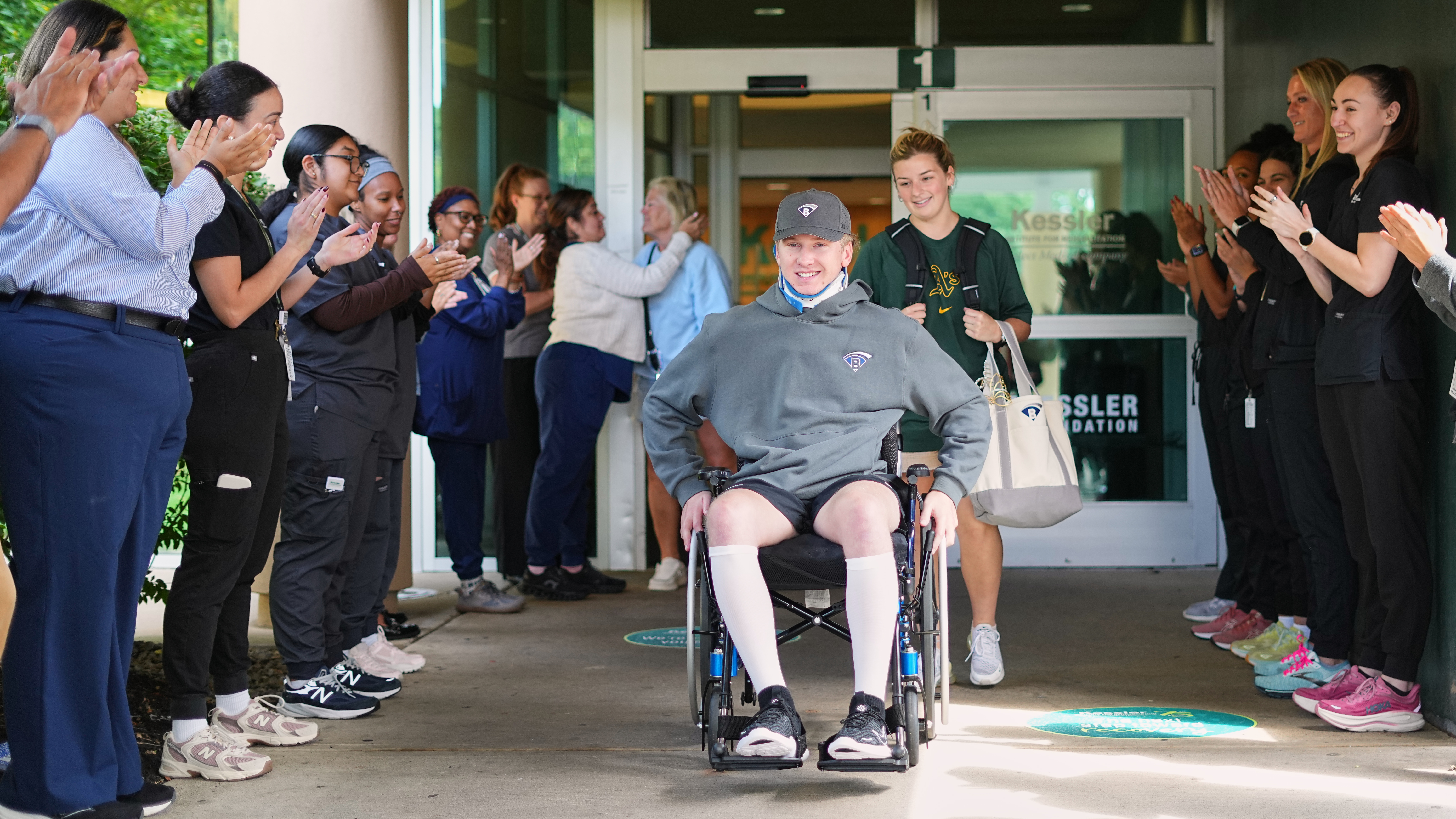 Caregivers clap out Ryan Lasko, a minor league prospect with the Athletics who was paralyzed in an outfield collision more than two months ago, upon his discharge from Kessler Institute for Rehabilitation in West Orange, N.J., Wednesday, Sept. 16, 2026. 