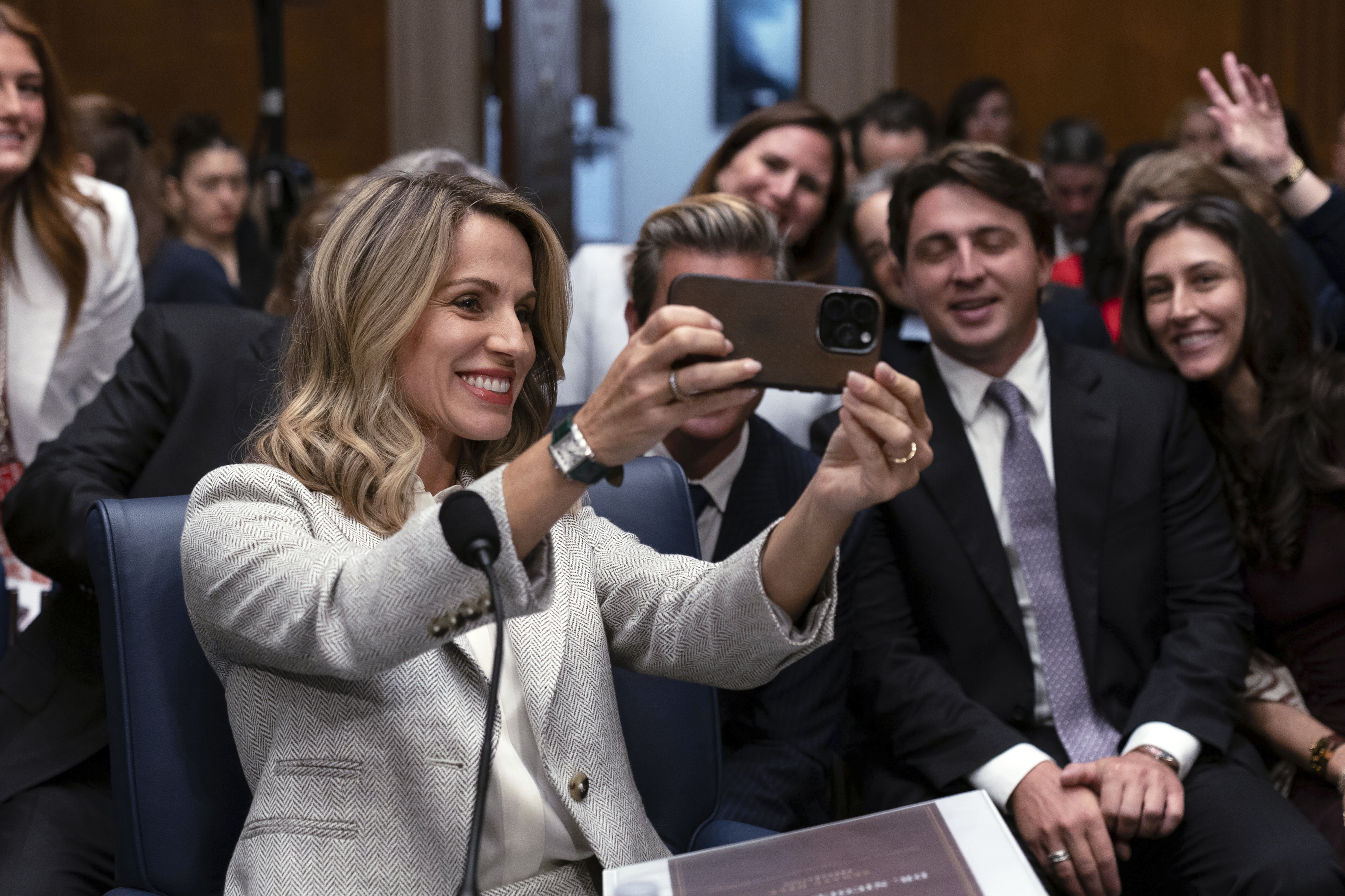 Dr. Nicole Saphier, surgeon general nominee, takes a selfie with family members before testifying at the Senate Committee on Health, Education, Labor and Pensions during her confirmation hearing on Capitol Hill Wednesday, in Washington. Saphier was grilled mainly on her stance on childhood vaccines.