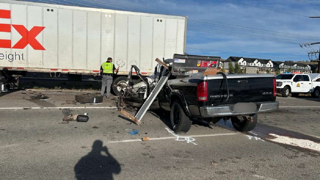 A fatal crash between a Dodge pickup and a FedEx semi-truck is pictured on Monday.
