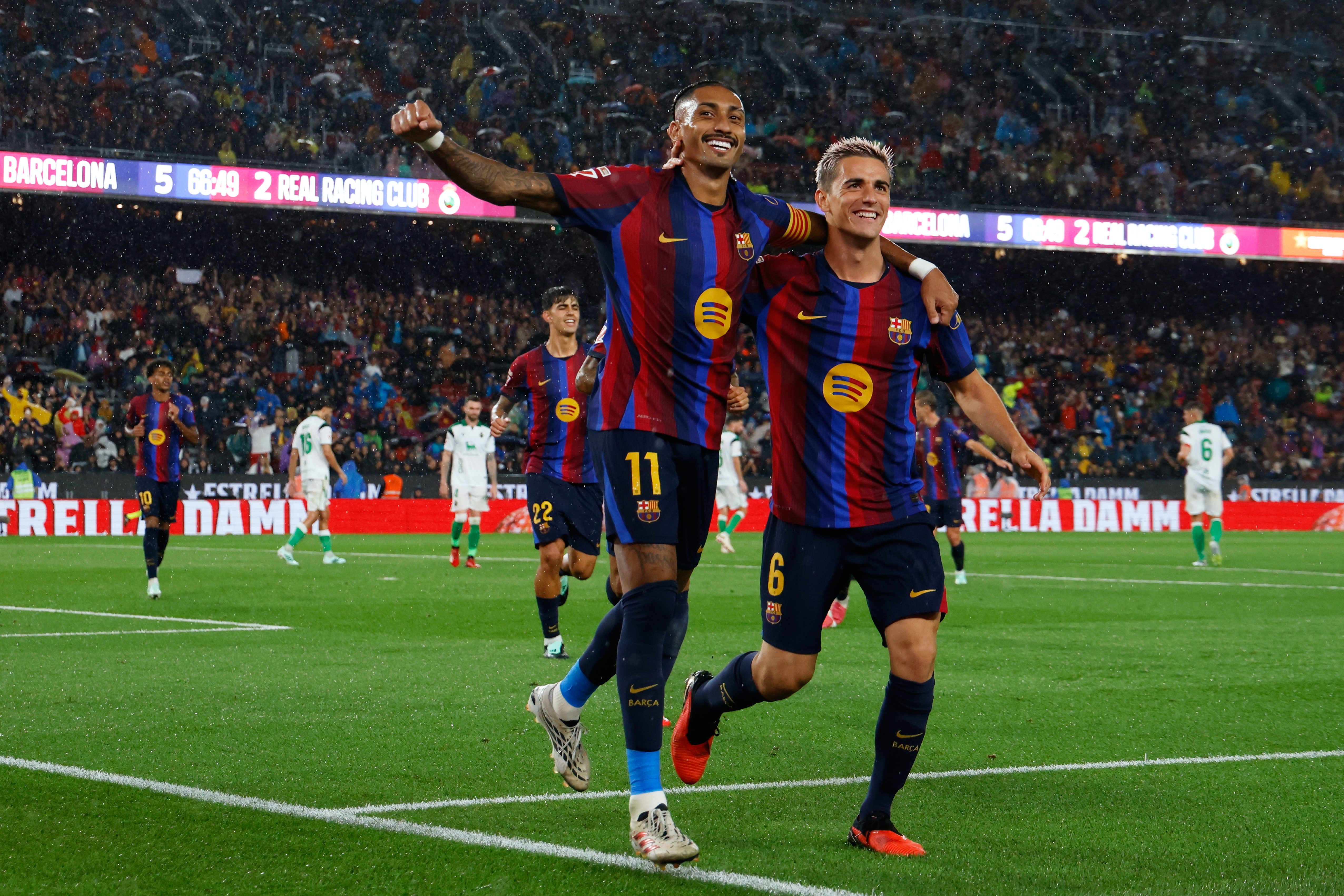 Barcelona's Raphinha celebrates with Gavi, right, after scoring his side's fifth goal from the penalty spot during a Spanish La Liga soccer match between Barcelona and Racing de Santander in Barcelona, Spain, Wednesday, Sept. 16, 2026. 