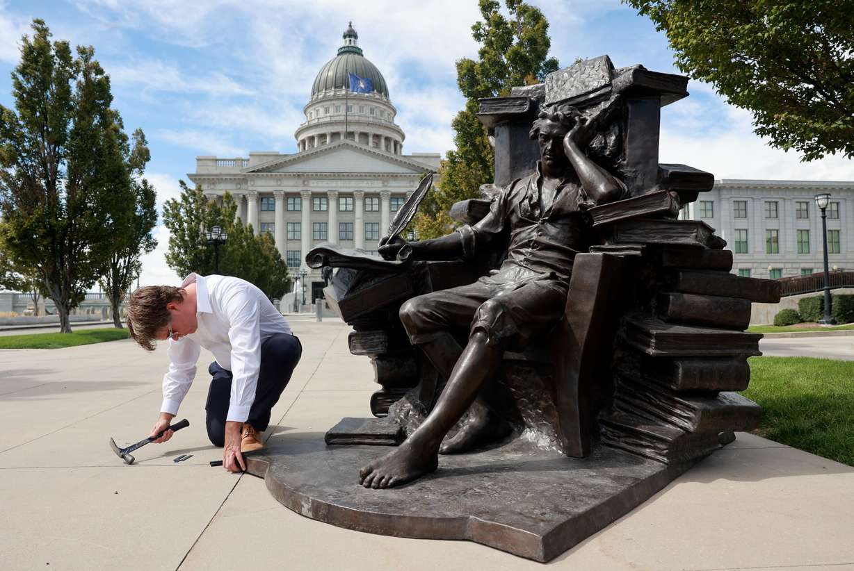 Michael Hall uses shims to level his sculpture of Thomas Jefferson outside of the Capitol in Salt Lake City on Wednesday.