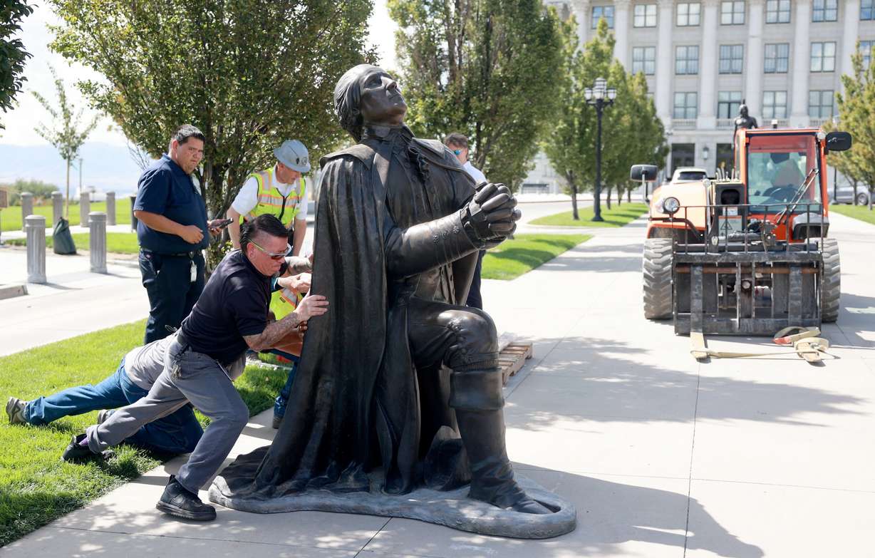 Omer Machuca, maintenance journeyman at the Capitol, helps move Steven Neal’s sculpture of George Washington outside of the Capitol in Salt Lake City on Wednesday.