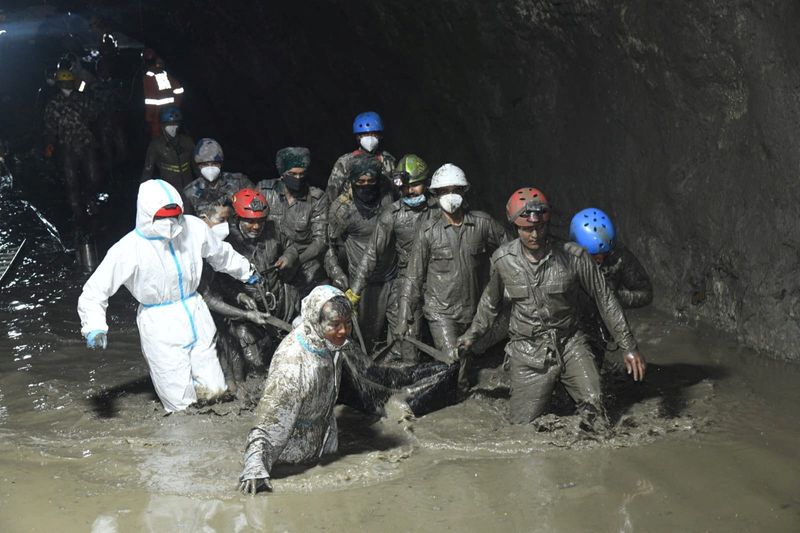Members of a search and rescue teams carry the body of a victim from the inside the Chilime Hydropower Project tunnel, following deadly flash floods and mudslides hit parts of Nepal, in this handout obtained by Reuters on September 16, 2026. Nepal Army/Handout via REUTERS