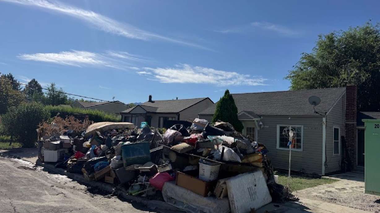 Items from a flooded Poplar Grove home are stacked up after a water main break on Aug. 16. Salt Lake City and the Utah Department of Transportation are now working to help residents still displaced a month after the flood, but remain at odds over who is responsible for the water main break.