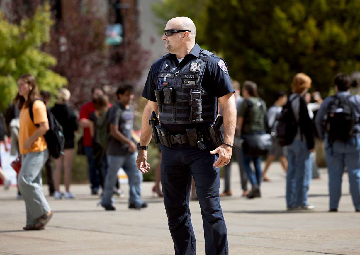 A University of Utah police officer patrols the campus as students write letters to the university’s dean of college affairs at the campus in Salt Lake City on Wednesday. The students say members of the College Republicans should be held accountable for posting a photo of a student that was later doxxed who approached them with a cake featuring a joke about Charlie Kirk's murder.