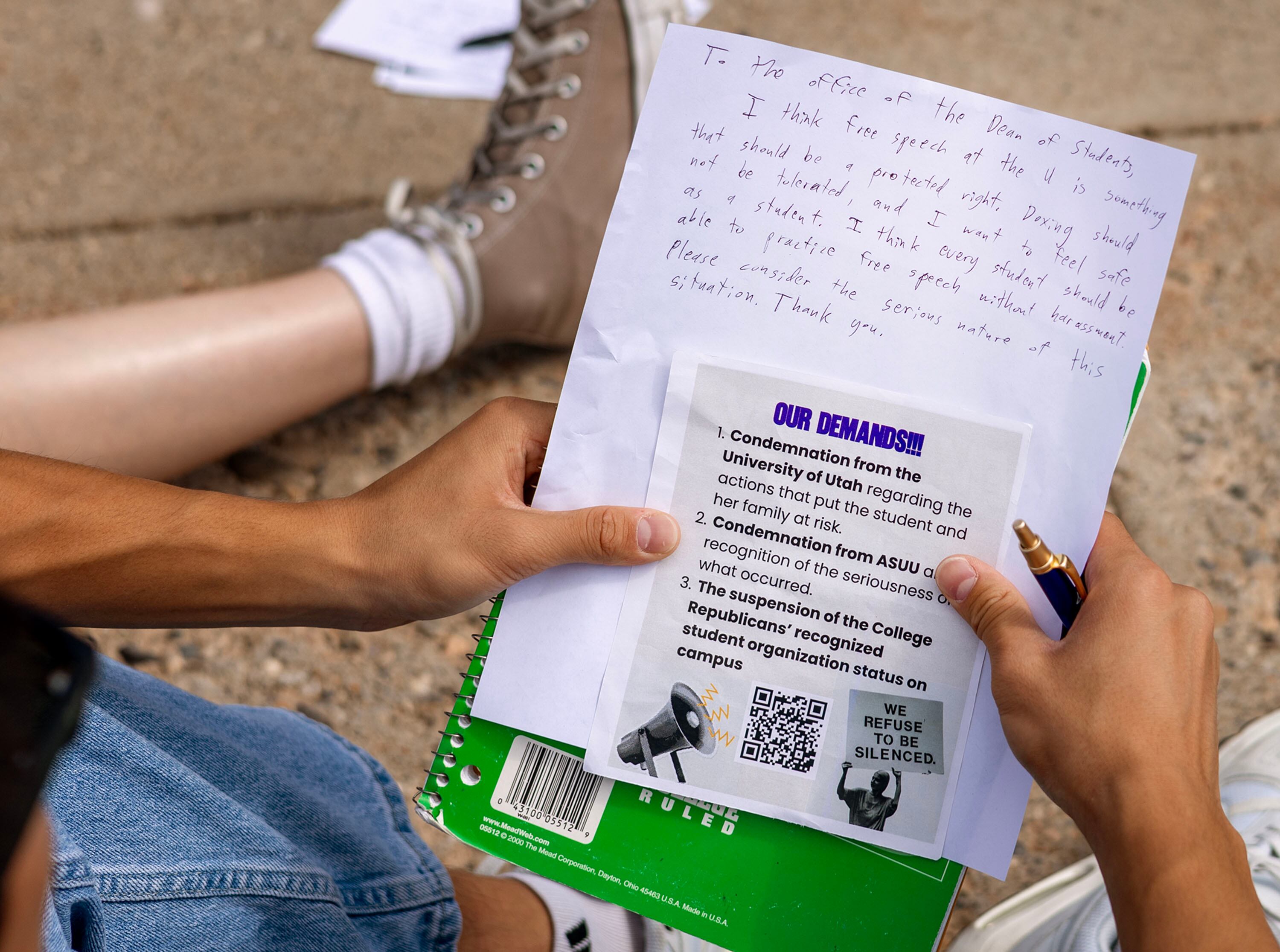 A group of University of Utah students write letters to the university’s dean of college affairs at the campus in Salt Lake City on Wednesday. The students say members of the College Republicans should be held accountable for posting a photo of a student that was later doxxed who approached them with a cake featuring a joke about Charlie Kirk's murder.