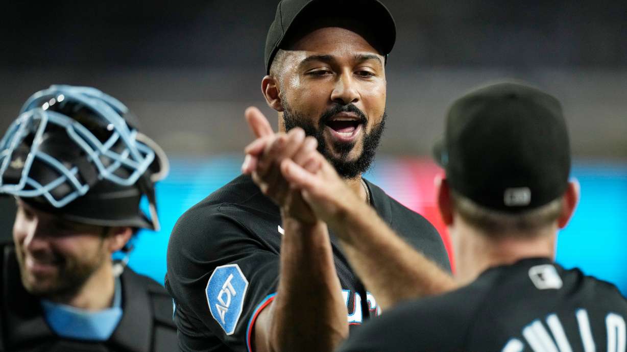 Miami Marlins pitcher Sandy Alcantara, left, celebrates a win against the Arizona Diamondbacks with Marlins manager Clayton McCullough after a baseball game, Wednesday, Sept. 16, 2026, in Phoenix.