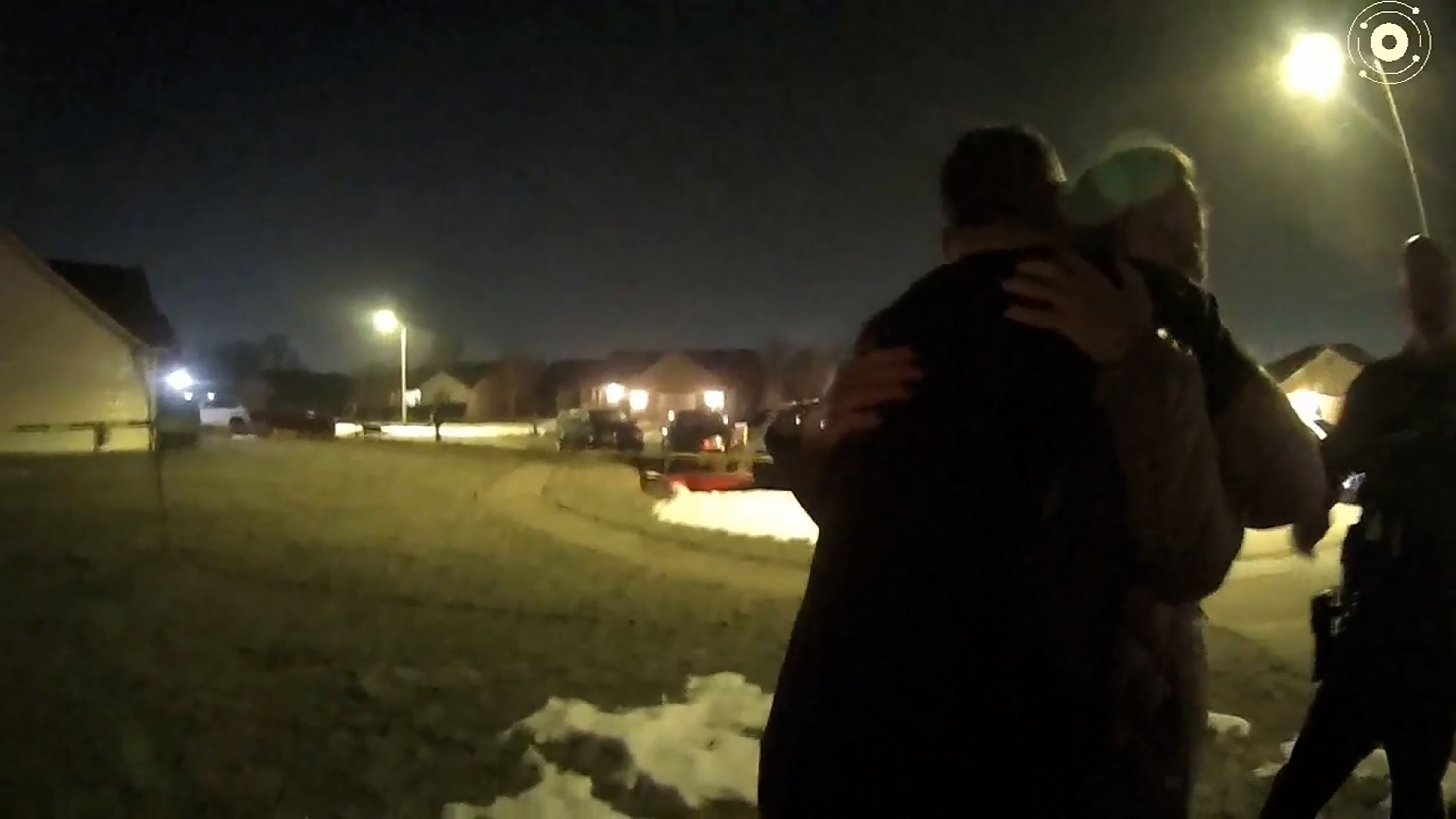 Caleb Flynn embraces his mother-in-law as law enforcement investigate the killing of his wife in February 2026.