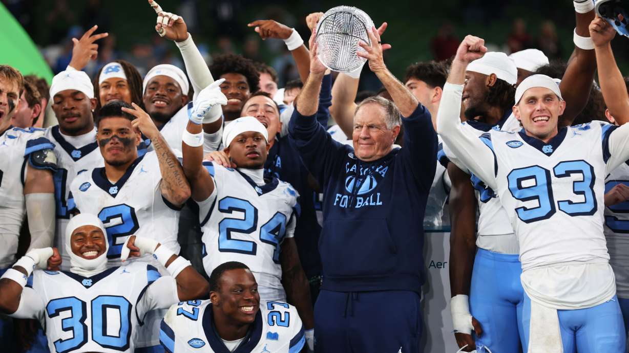 North Carolina head coach Bill Belichick, center right, and his team celebrate after defeating TCU in an NCAA college football game in Dublin, Ireland, Saturday, Aug. 29, 2026.