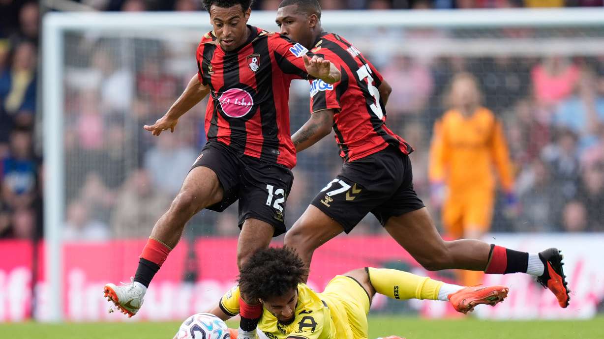Brentford's Kevin Schade is challenged by Bournemouth's Tyler Adams, left, and Rayan during the English Premier League soccer match between Bournemouth and Brentford in Bournemouth, England, Saturday Sept. 12, 2026.