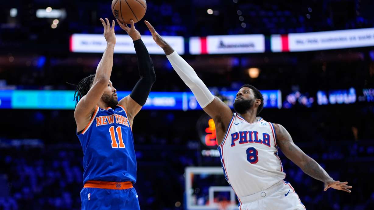 FILE - New York Knicks' Jalen Brunson, left, goes up for a shot against Philadelphia 76ers' Paul George during the first half of Game 4 in a second-round NBA basketball playoffs series, May 10, 2026, in Philadelphia.