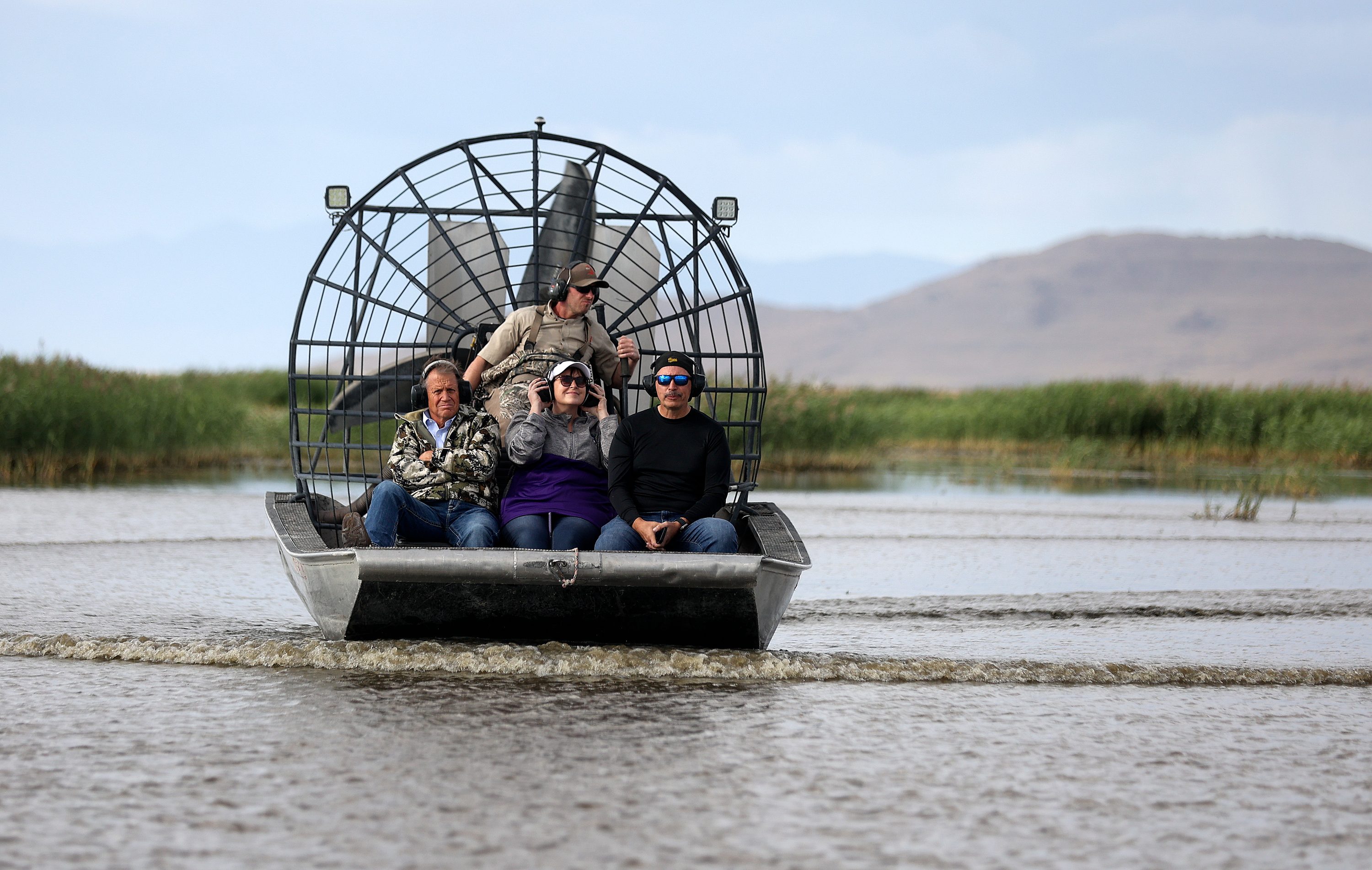 Rich Hansen, Utah Division of Wildlife Resources wildlife biologist, drives as Sen. Keven Stratton, R-Orem, Stephanie Hollist, Utah Senate District 7 candidate, and Sen. Daniel McCay, R-Riverton, ride in an airboat through Farmington Bay on the eastern side of the Great Salt Lake on Thursday.