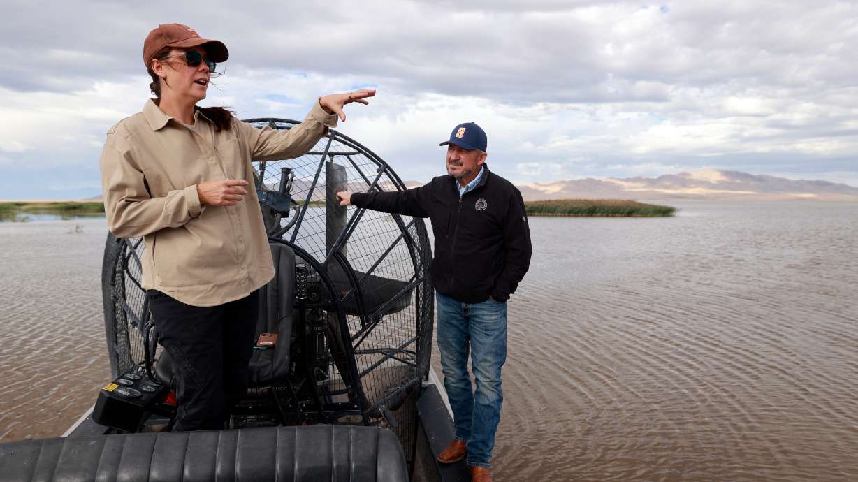 Ashley Kijowski, Utah Division of Wildlife Resources water fowl program manager, talks with Sen. Derrin Owens, R-Fountain Green, as they pause during an airboat ride through Farmington Bay on the eastern side of the Great Salt Lake on Thursday.