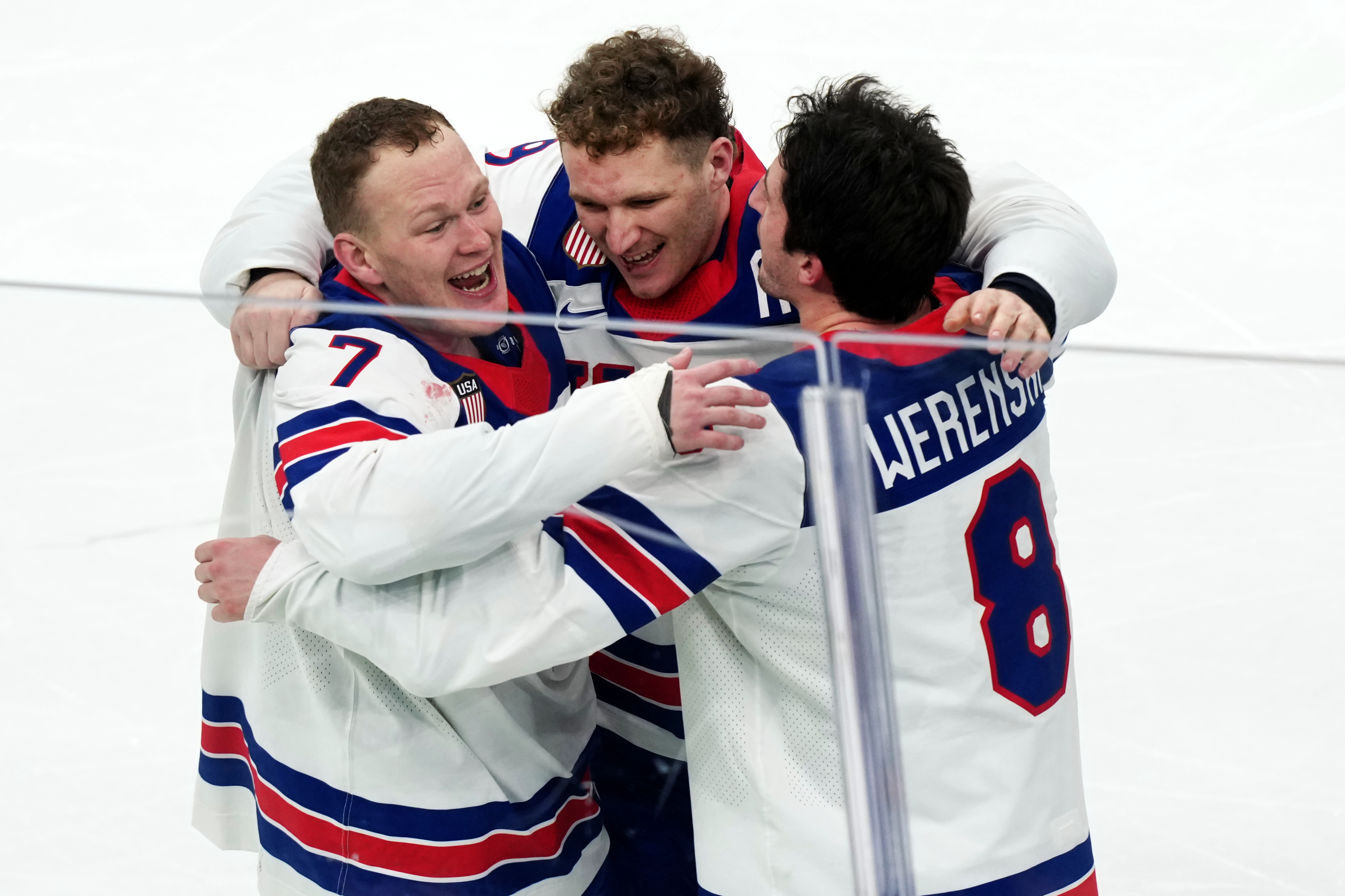 FILE - United States' Brady Tkachuk (7), Matthew Tkachuk, center, and Zach Werenski (8) celebrate after their overtime win against Canada in the men's ice hockey gold medal game at the 2026 Winter Olympics in Milan on Feb. 22, 2026. 