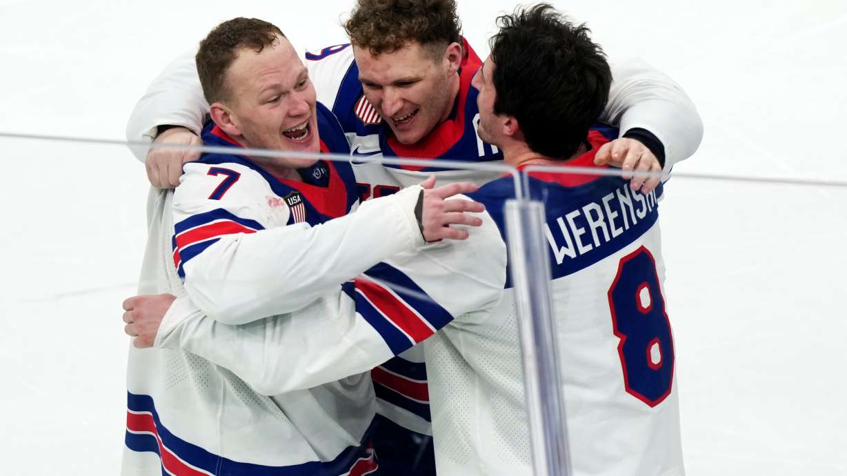 FILE - United States' Brady Tkachuk (7), Matthew Tkachuk, center, and Zach Werenski (8) celebrate after their overtime win against Canada in the men's ice hockey gold medal game at the 2026 Winter Olympics in Milan on Feb. 22, 2026.