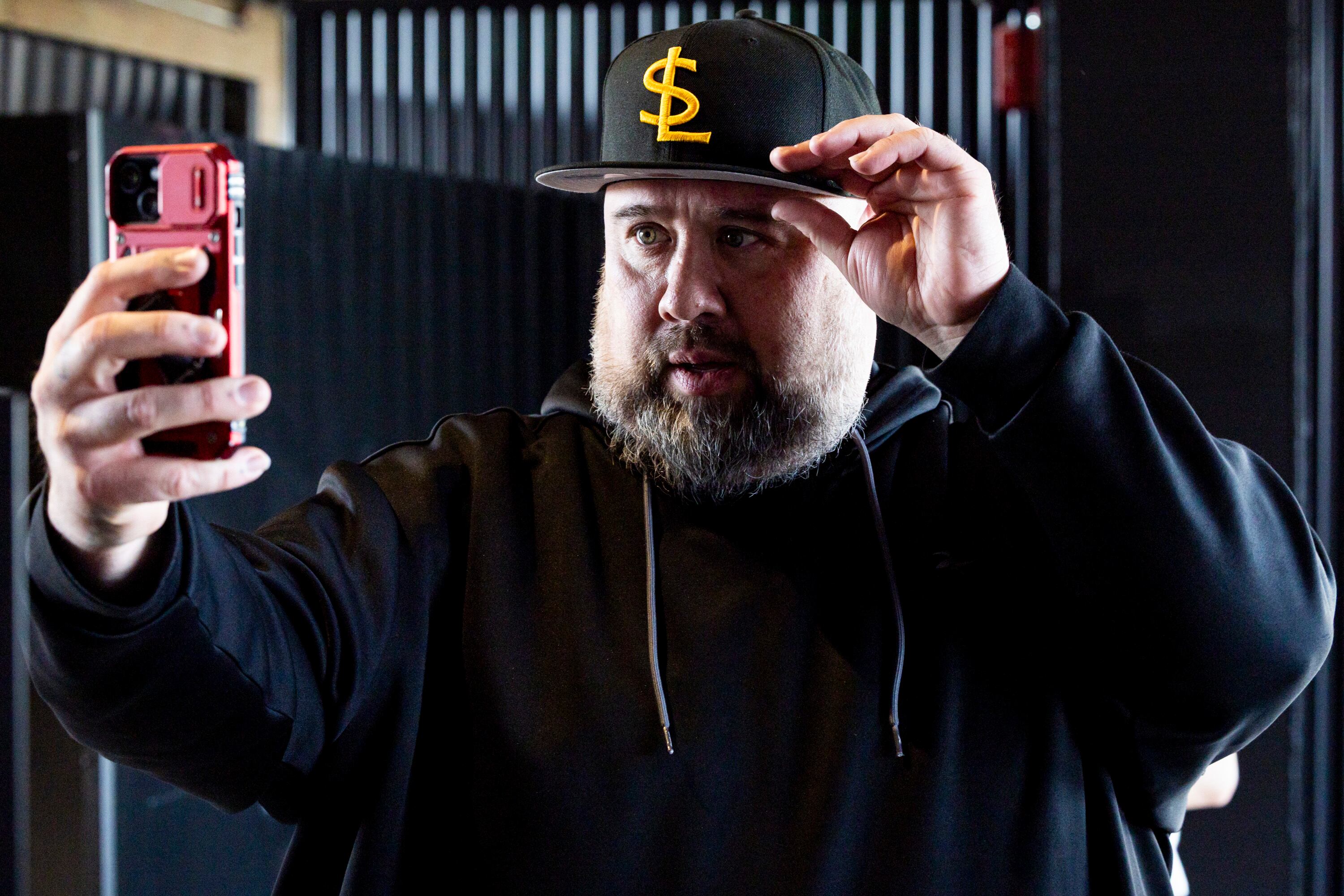 Paul Najar of Sandy tries on a Salt Lake Bees hat before the Bees’ inaugural home opener against the Reno Aces held at The Ballpark at America First Square in South Jordan on April 8, 2025. Miller Company CEO Steve Starks said Utahns have always embraced baseball, helping its cause to bring Major League Baseball to the state.
