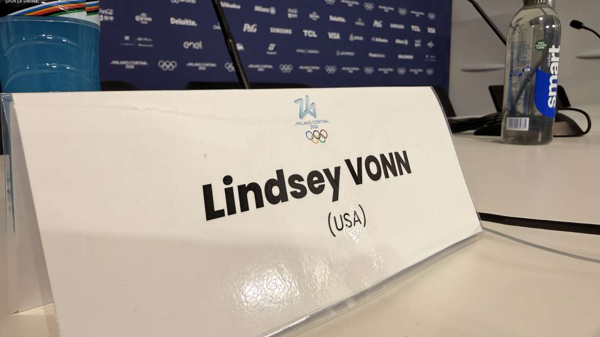A placard marks Lindsey Vonn’s seat at a February press conference in Cortina, Italy, ahead of her competition. Vonn said scammers are creating fake accounts impersonating her. The warning comes as con artists increasingly use AI and deepfakes to make celebrity scams harder to spot.