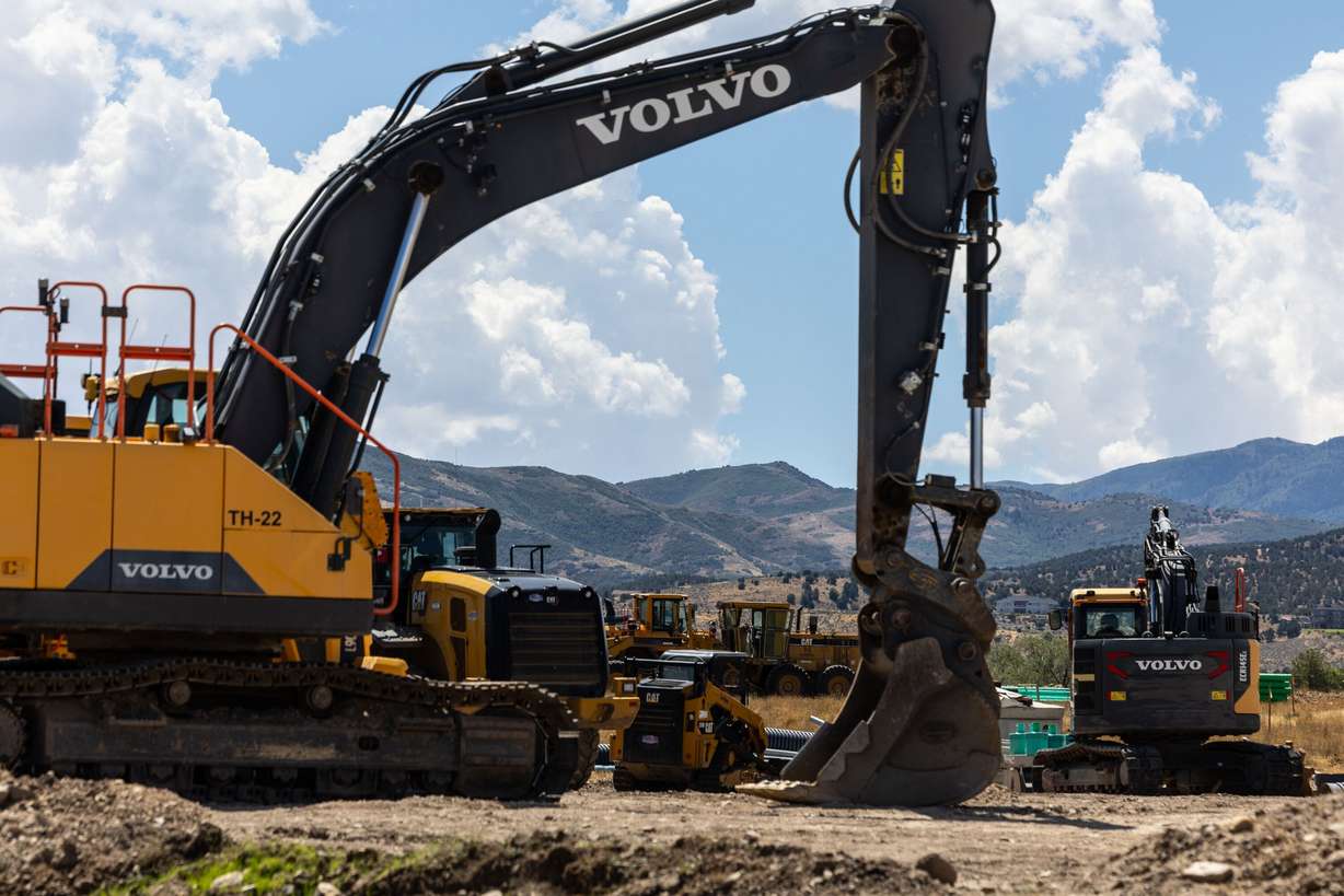 Large construction vehicles are parked for when workers return to build homes in Herriman on Aug. 22. Mortgage rates brushed 7% earlier this week, leaving people jittery.