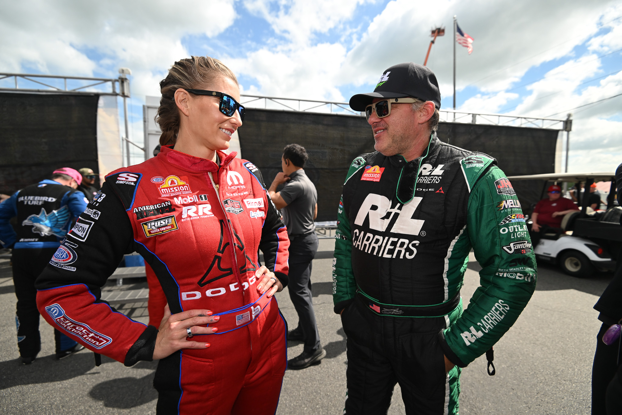 Married NHRA drivers Leah Pruett, left, and Tony Stewart chat pre-race at New England Dragway in Epping, NH, Sunday, June 7, 2026, for the NHRA New England Nationals. 