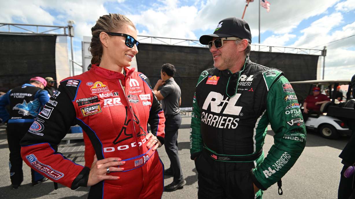 Married NHRA drivers Leah Pruett, left, and Tony Stewart chat pre-race at New England Dragway in Epping, NH, Sunday, June 7, 2026, for the NHRA New England Nationals.