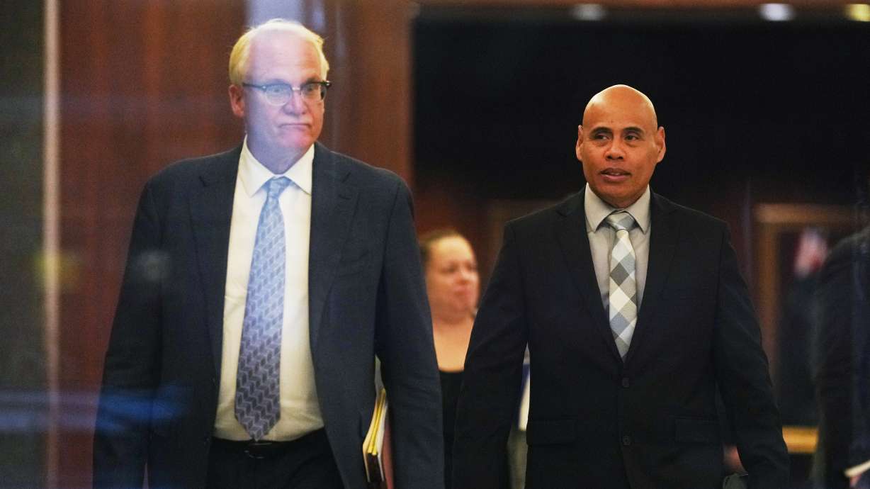 Christian Castro, an immigration officer accused of shooting a Venezuelan man during the immigration crackdown in Minneapolis early this year and lying to investigators about what happened, leaves with his attorney Daniel Gerdts after a hearing at the Warren E. Burger Federal Building, Friday, in St. Paul, Minn. Castro pleaded not guilty to the charges.