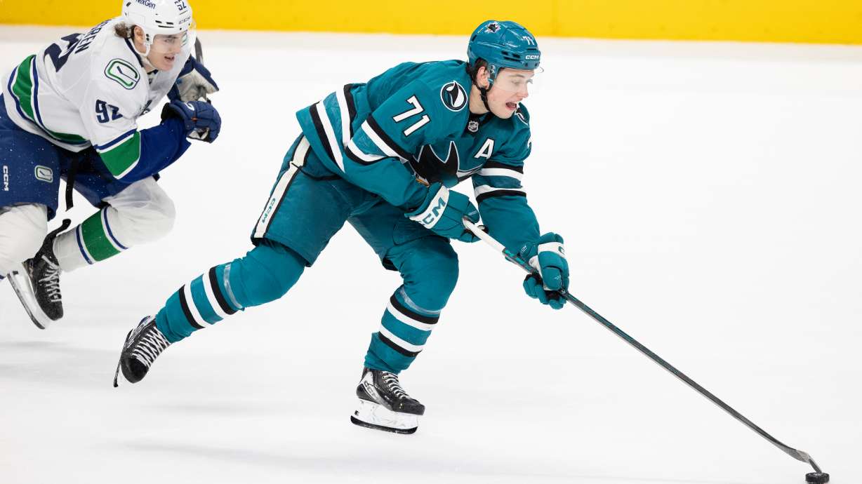 FILE - San Jose Sharks center Macklin Celebrini (71) drives the puck as Vancouver Canucks left wing Liam Ohgren (92) defends during the third period of their NHL ice hockey game in San Jose, Calif., Saturday, April 11, 2026.