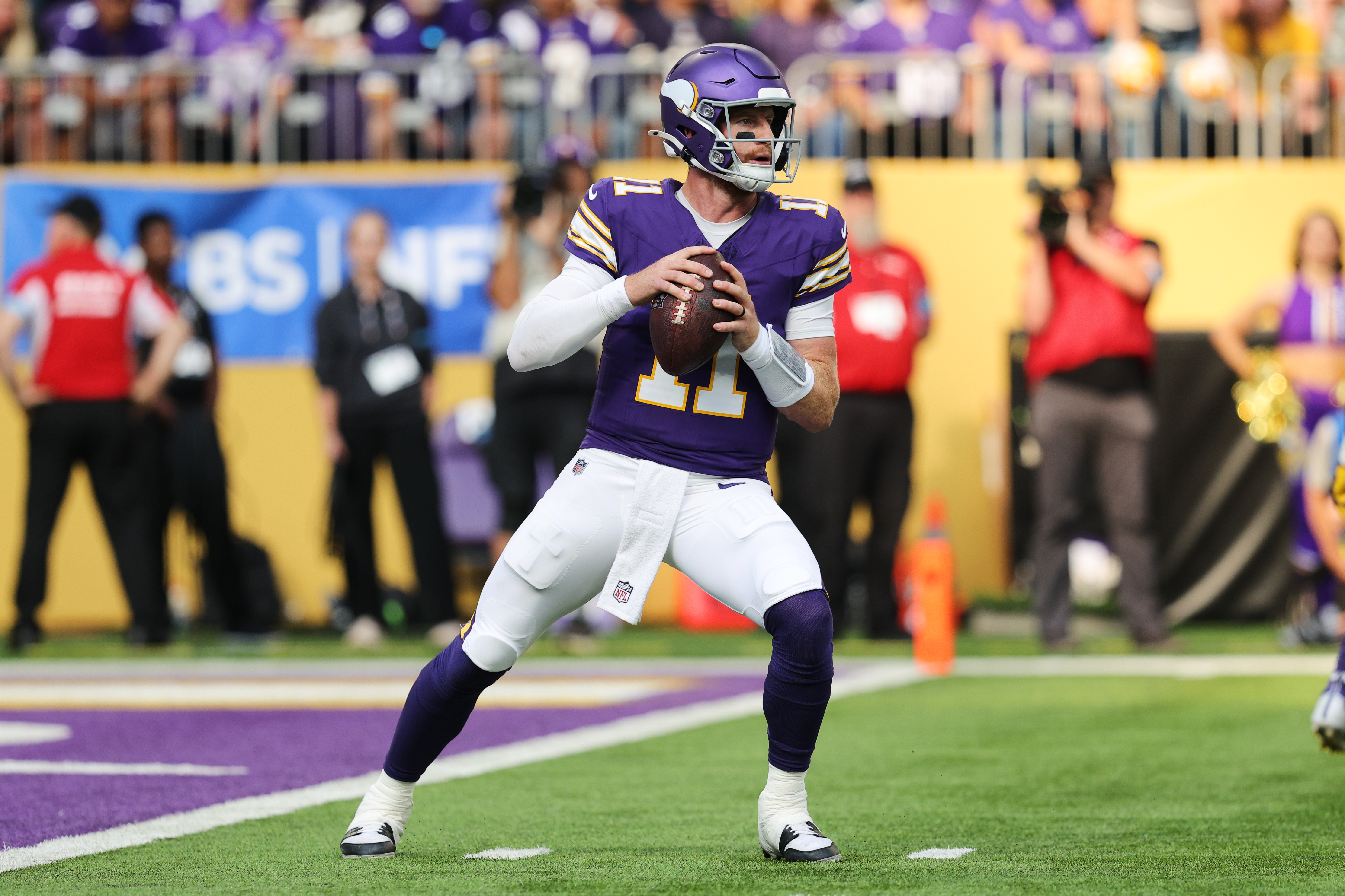 Minnesota Vikings quarterback Carson Wentz (11) drops back to pass during the first half of an NFL football game against the Green Bay Packers, Sunday, Sept. 13, 2026, in Minneapolis, Minn. 