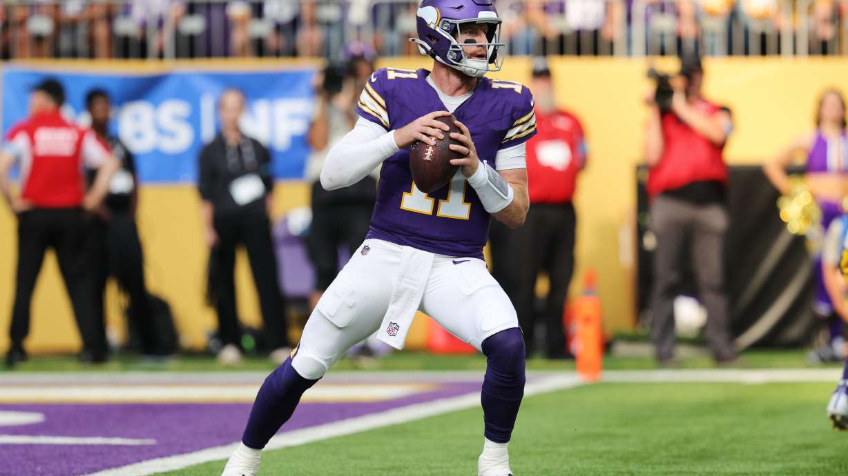 Minnesota Vikings quarterback Carson Wentz (11) drops back to pass during the first half of an NFL football game against the Green Bay Packers, Sunday, Sept. 13, 2026, in Minneapolis, Minn.