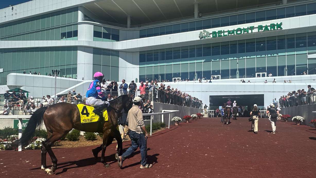 In this photo made with a smartphone, jockeys ride their horses into the newly-opened Belmont Park in Elmont, N.Y., on Friday, Sept. 18, 2026.