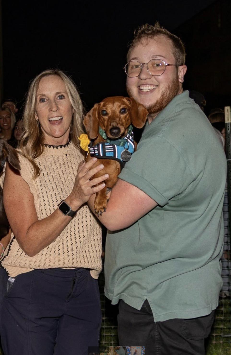 Stacy Schmidt and Ry Iverson pose with Peanut during the 2025 Weenie Mania at Utah Tech University.