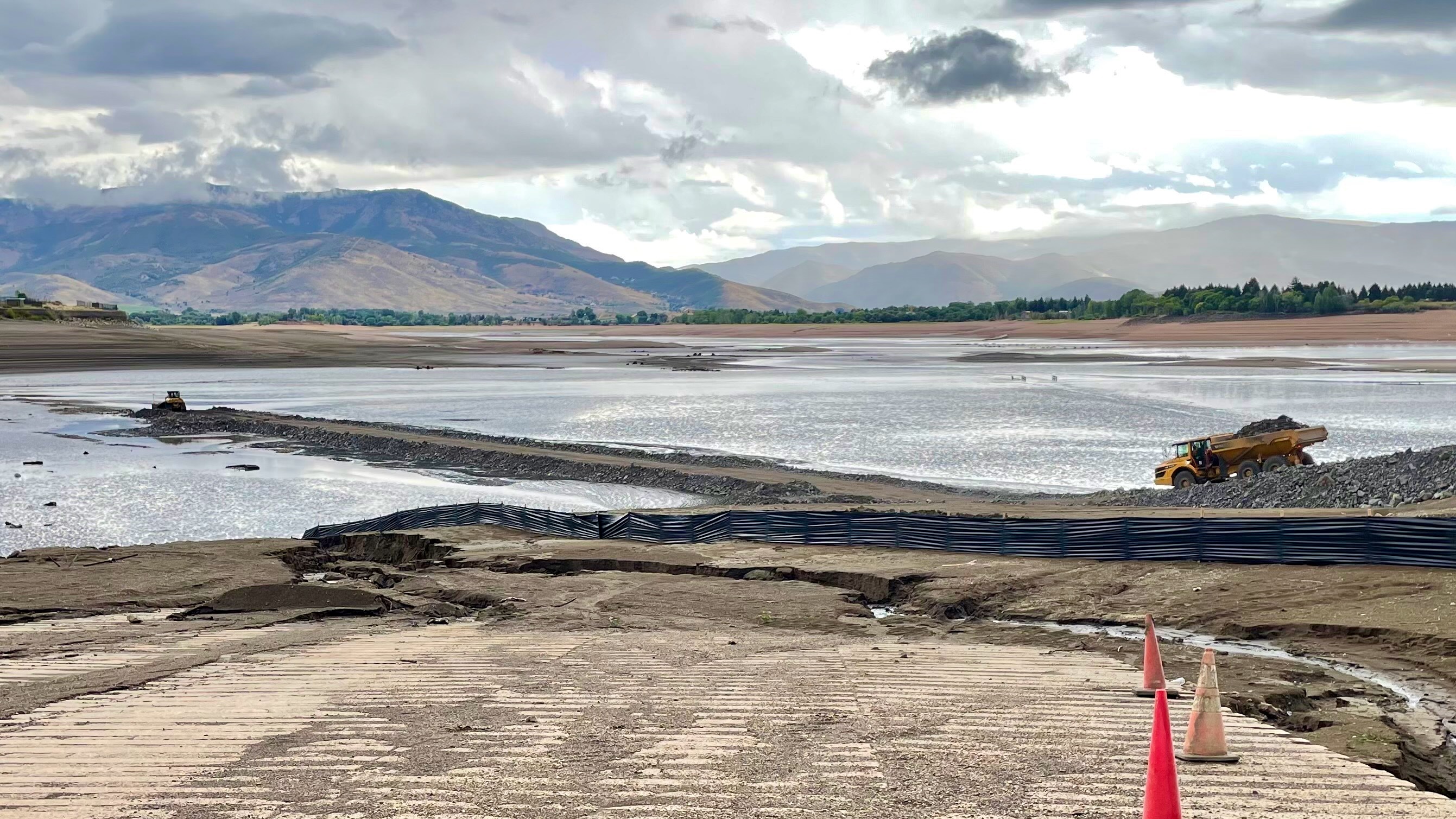 A truck hauls material to build up a temporary road across Pineview Reservoir in Weber County on Friday. The roadway will be used to help install a new section of water pipeline crossing the reservoir.
