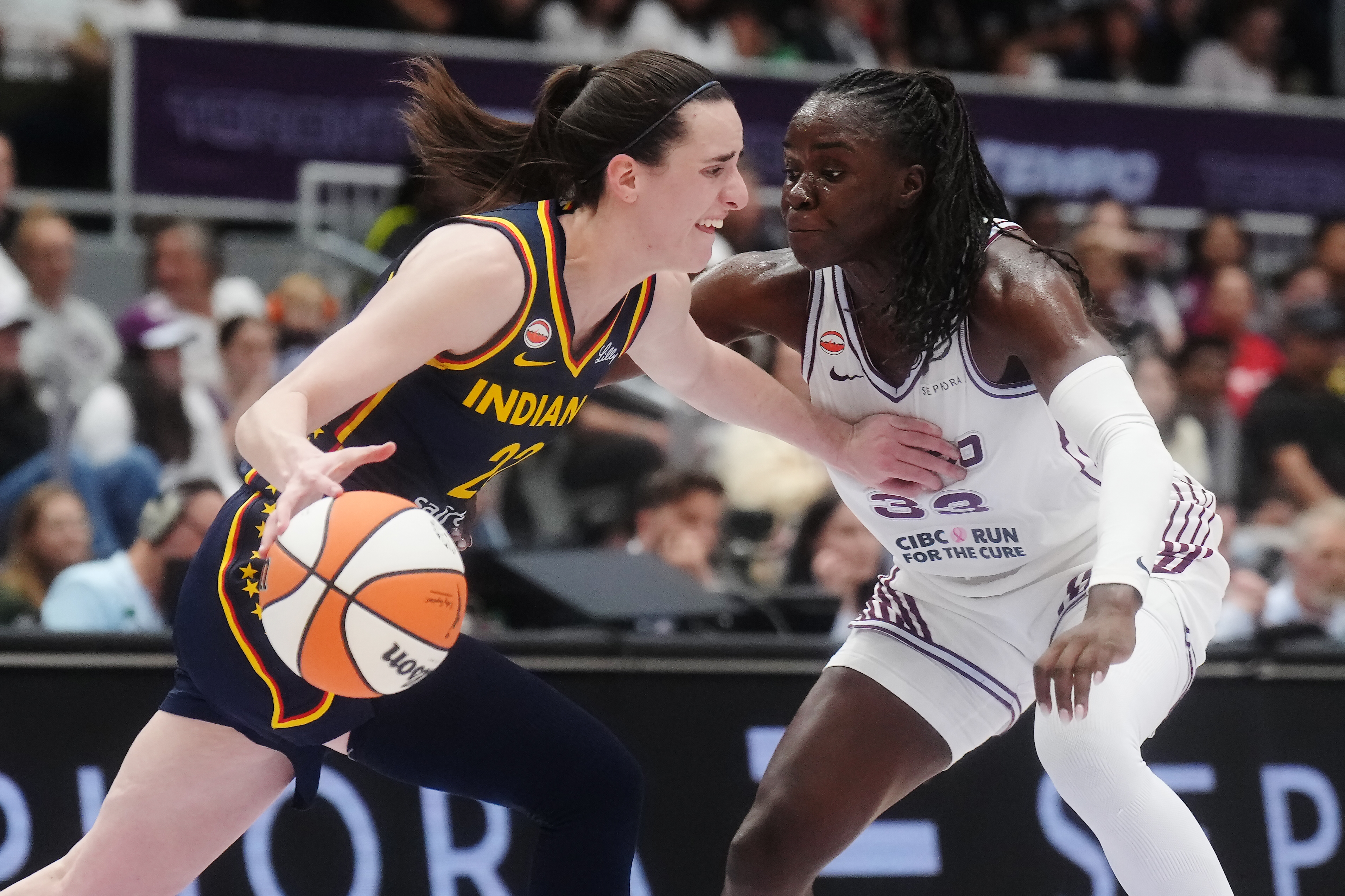 Indiana Fever's Caitlin Clark (22) drives as Toronto Tempo's Ornella Bankole (33) defends during first half WNBA basketball action in Toronto on Friday, Sept. 18, 2026. 