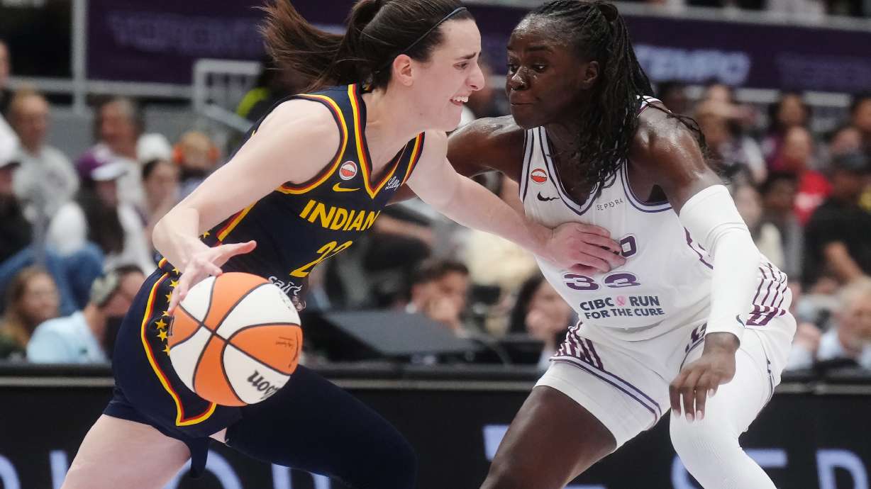 Indiana Fever's Caitlin Clark (22) drives as Toronto Tempo's Ornella Bankole (33) defends during first half WNBA basketball action in Toronto on Friday, Sept. 18, 2026.