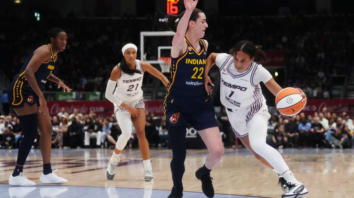 Toronto Tempo's Teonni Key, right, drives as Indiana Fever's Caitlin Clark (22) defends during the first half of a WNBA basketball game in Toronto, Friday, Sept. 18, 2026.