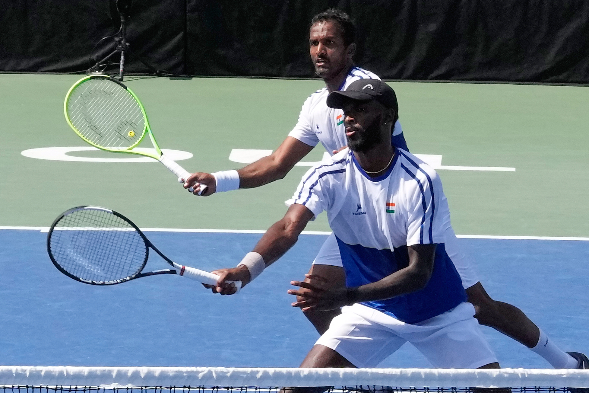 India's Dhakshineswar Suresh, front, returns the ball as his teammate N Sriram Balaji watches during a double match of a Davis Cup World second-round qualifier against South Korea's Nam Jisung and Park Uisung in Seoul, South Korea, Saturday, Sept. 19, 2026. 