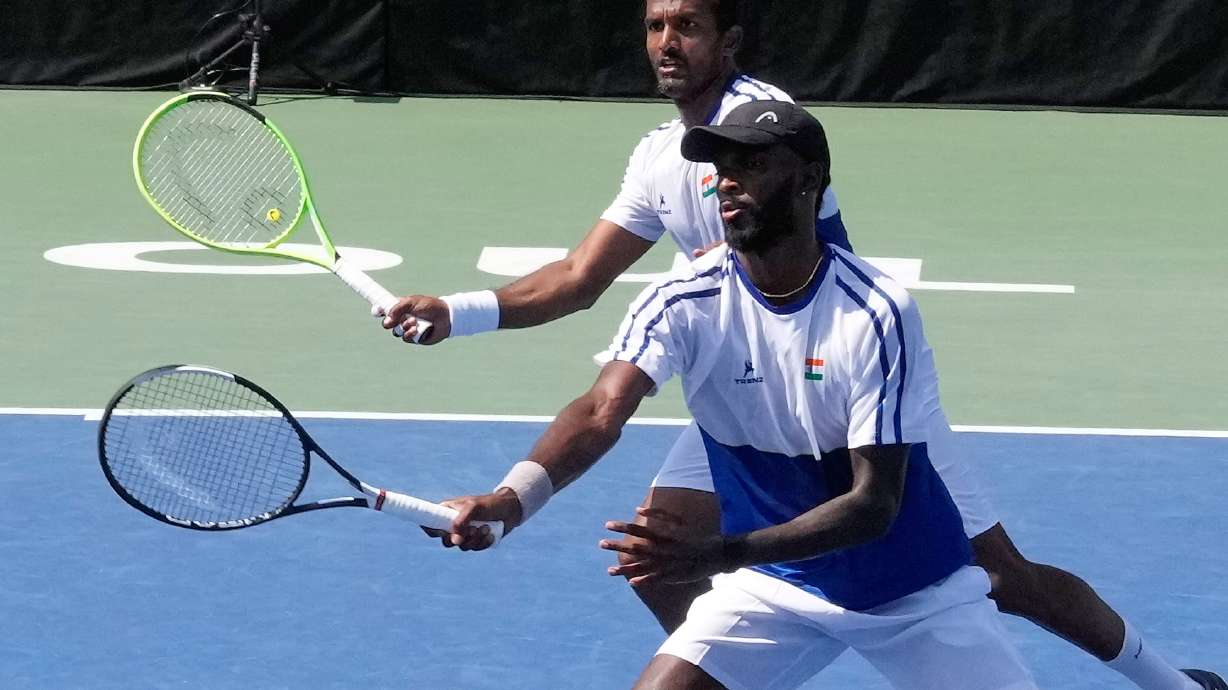 India's Dhakshineswar Suresh, front, returns the ball as his teammate N Sriram Balaji watches during a double match of a Davis Cup World second-round qualifier against South Korea's Nam Jisung and Park Uisung in Seoul, South Korea, Saturday, Sept. 19, 2026.