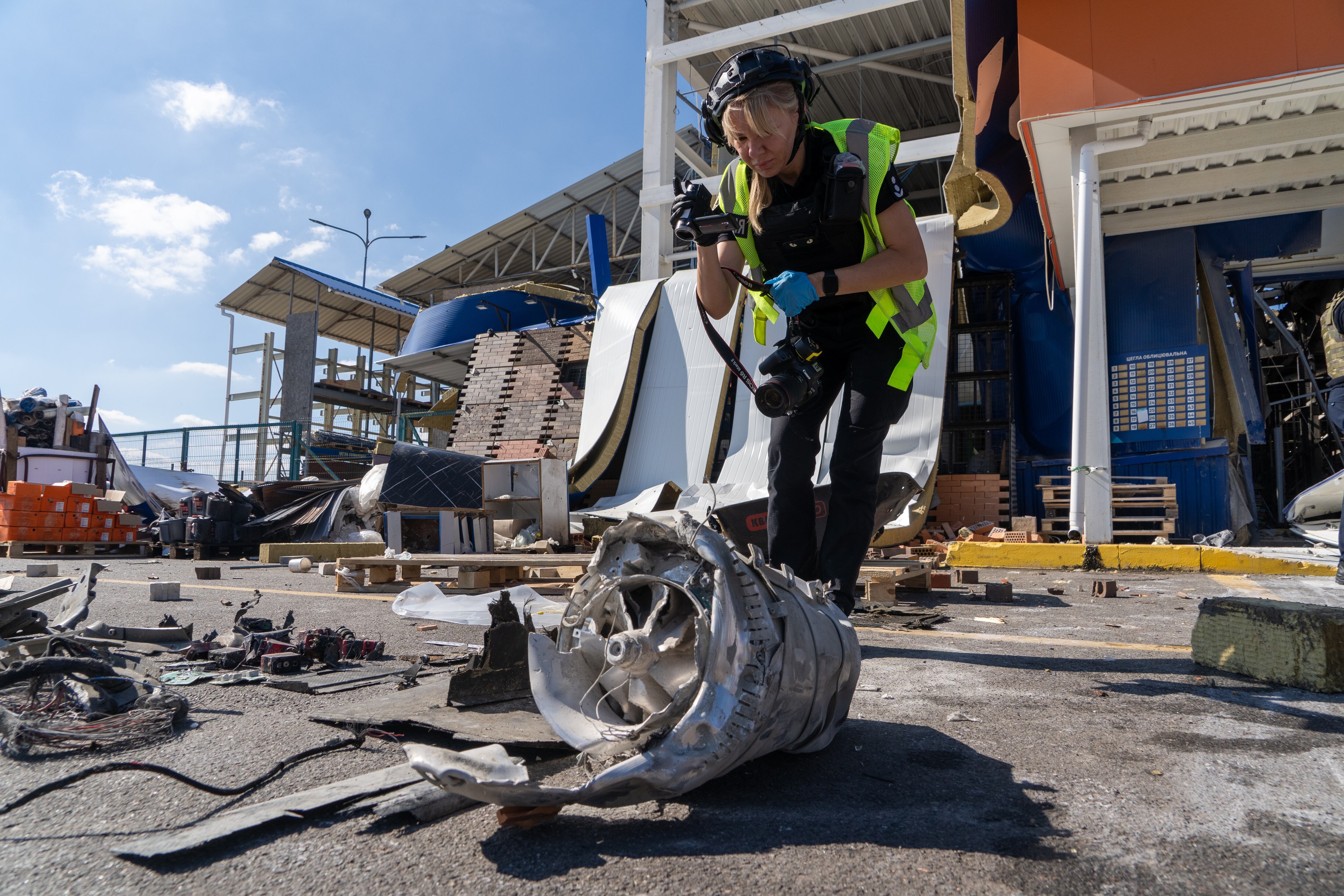 A police officer inspects fragments of a Russian drone after an air attack on a commercial infrastructure in Kharkiv, Ukraine, on Thursday.