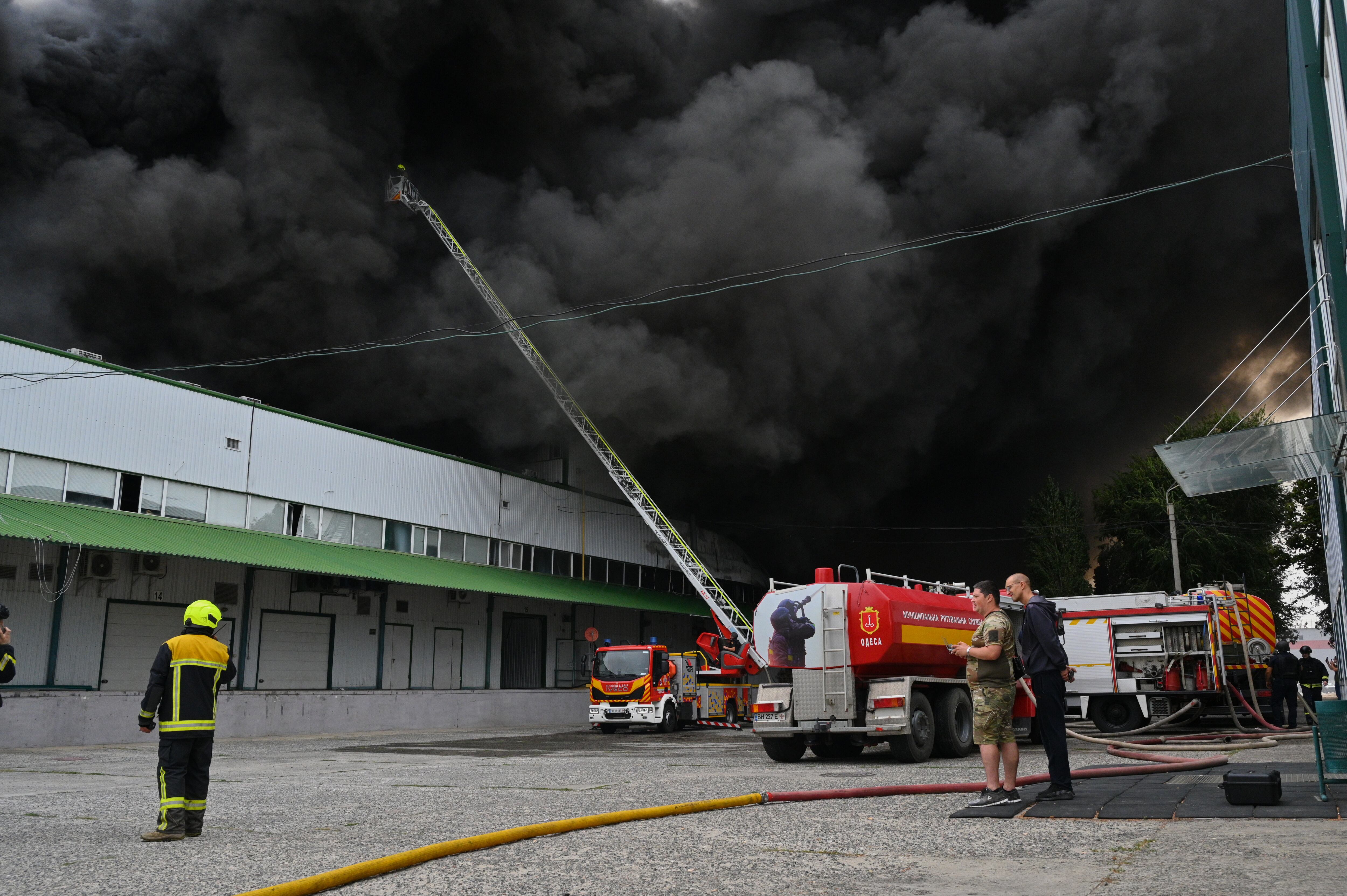 Firefighters put out a fire at warehouse stores after a Russian air attack in Odesa, Ukraine, Sunday, Sept. 13.