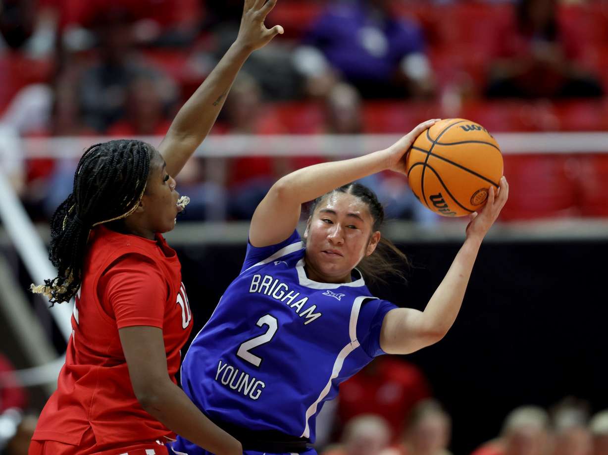 BYU Cougars guard Sydney Benally (2) keeps the ball from Utah Utes guard LA Sneed (2) at the Huntsman Center in Salt Lake City on Feb. 21.