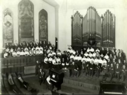 Labeled as "Easter 1915," this photograph shows the interior of the First United Methodist Church, with the original organ and stained glass windows visible behind a choir.