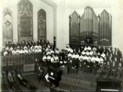 Labeled as "Easter 1915," this photograph shows the interior of the First United Methodist Church, with the original organ and stained glass windows visible behind a choir.