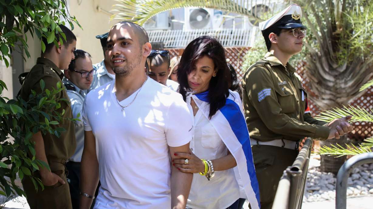 Elor Azaria, escorted by his mother, arrives to Israeli military court on July 30, 2017, in Tel Aviv, Israel. Azaria was pardoned on Saturday by Israel for shooting a Palestinian attacker from close range a decade ago.