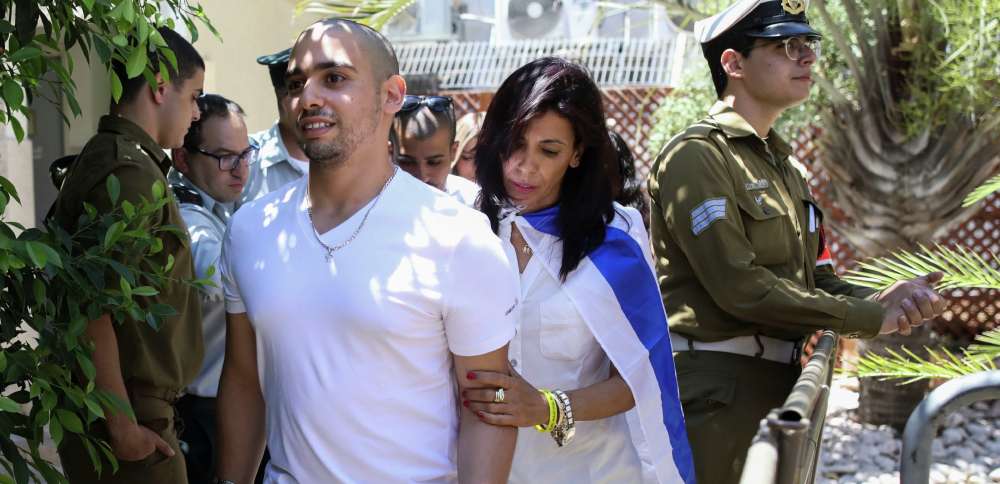 Israel's president pardons a combat medic whose shooting of a Palestinian attacker caused debate