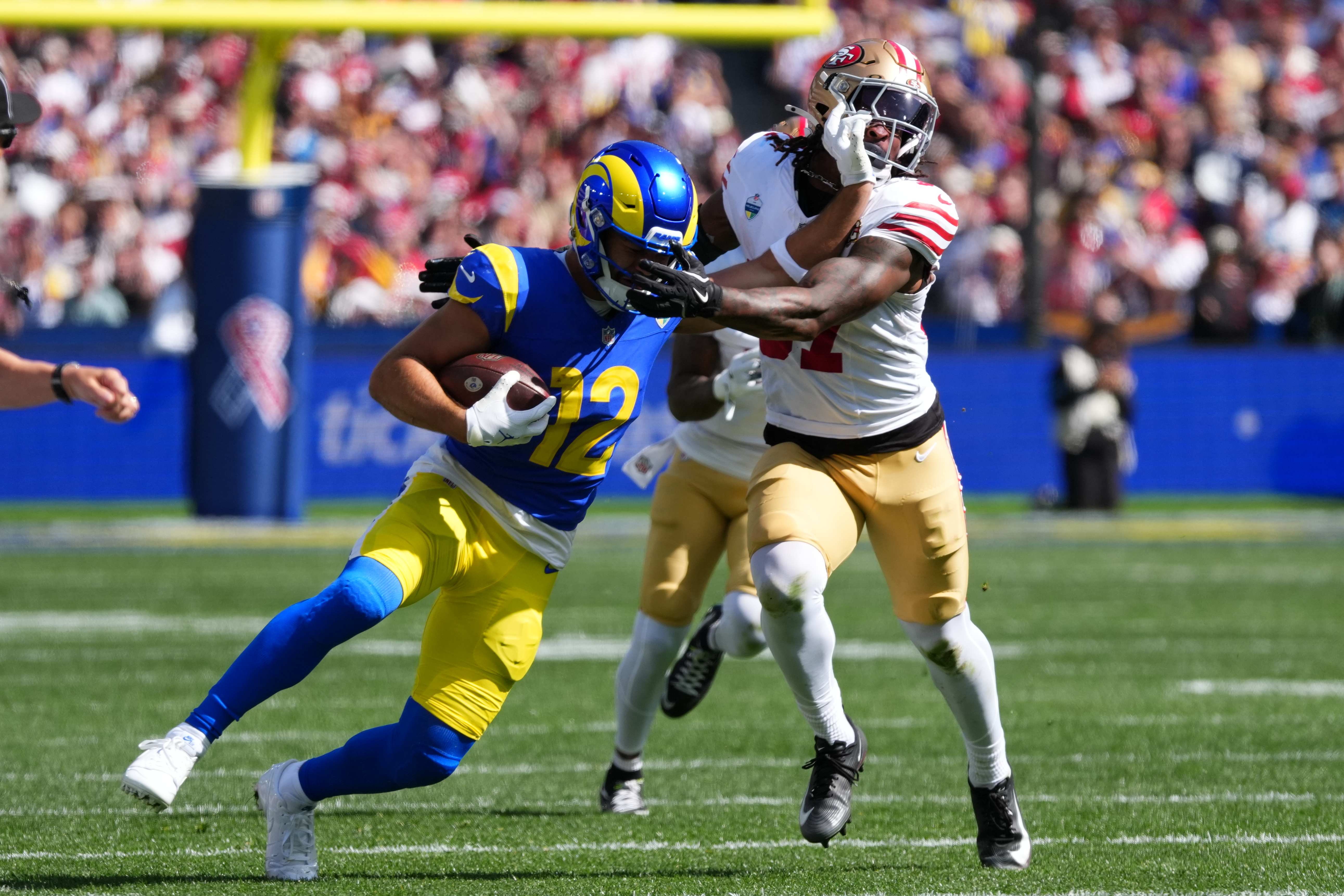 Los Angeles Rams wide receiver Puka Nacua runs pass San Francisco 49ers safety Ji'ayir Brown during the first half of an NFL football game, Friday, Sept. 11, 2026, in Melbourne, Australia. 