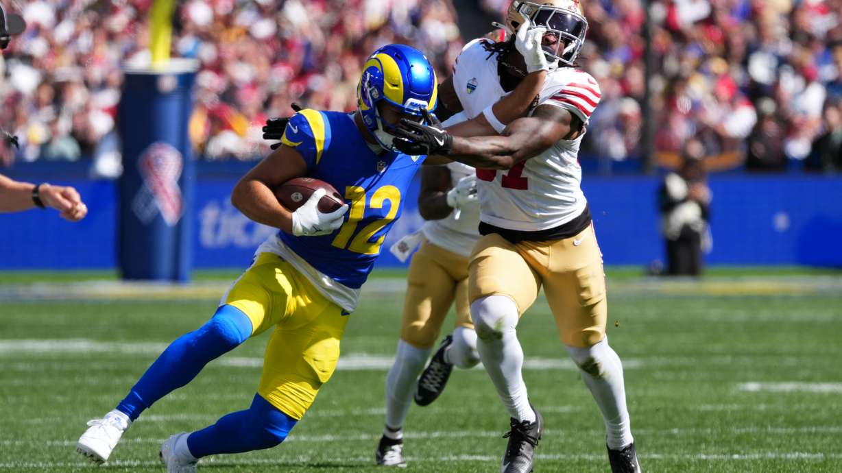 Los Angeles Rams wide receiver Puka Nacua runs pass San Francisco 49ers safety Ji'ayir Brown during the first half of an NFL football game, Friday, Sept. 11, 2026, in Melbourne, Australia.