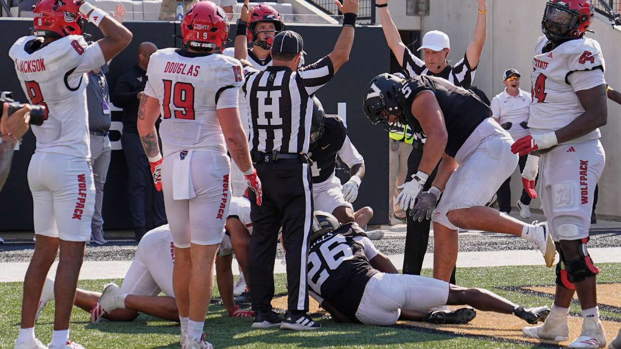 Officials signal touchdown after Vanderbilt cornerback Cayden Daniels (26) recovered a North Carolina State fumble in the end zone during the second half of an NCAA college football game Saturday, Sept. 19, 2026, in Nashville, Tenn.